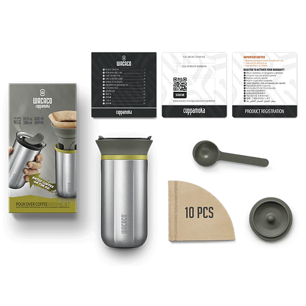 Wacacos Cuppamoka bærbare pour-over-kaffemaskine inkluderer et rustfrit stålkrus, filterholder, scoop, 10 papirfiltre og instruktioner i produktæsken. Kruset har en metalfinish med et grønlig-grå låg.